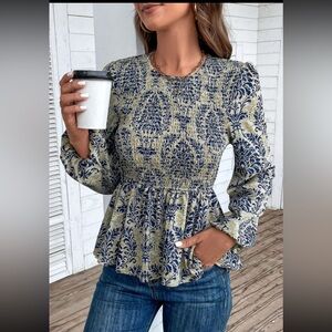 1099. Peplum smocked puff long sleeve top in blue